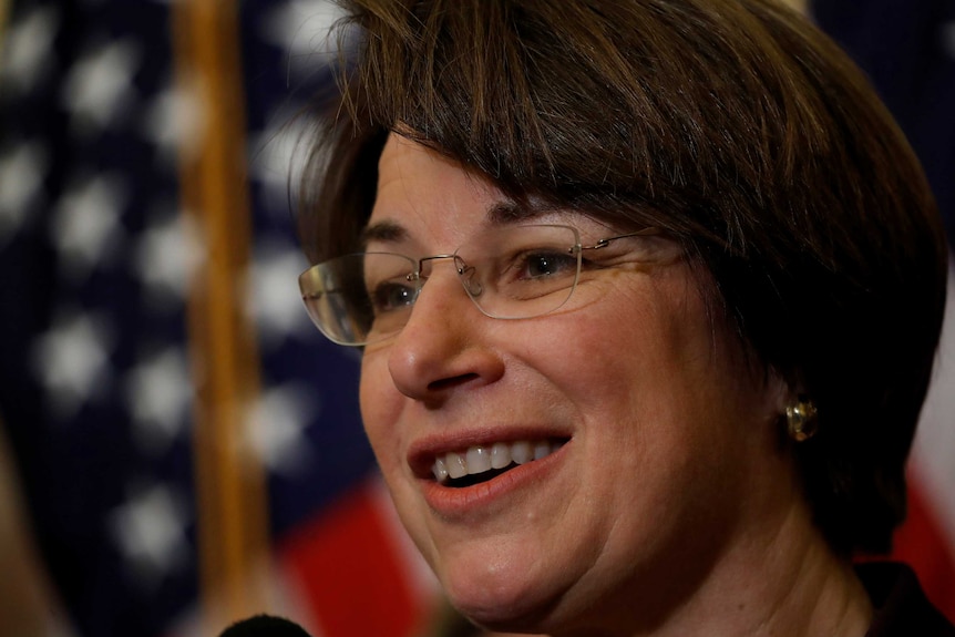 A close-up of a woman wearing glasses