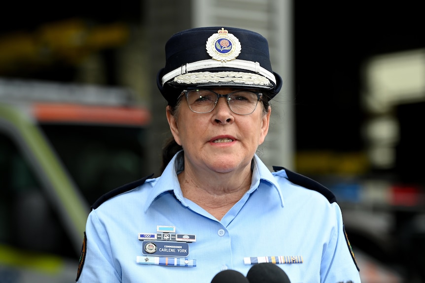 A woman police officer wearing glasses speaking