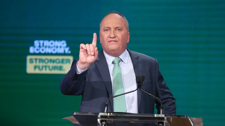Barnaby Joyce gestures while talking at a lectern.