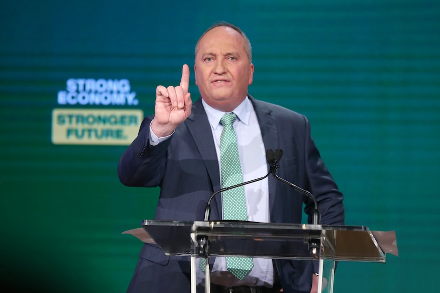 Barnaby Joyce gestures while talking at a lectern.