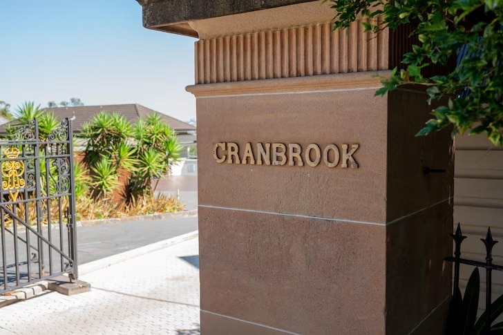 A sunny image of the grand front gate of Cranbrook private school