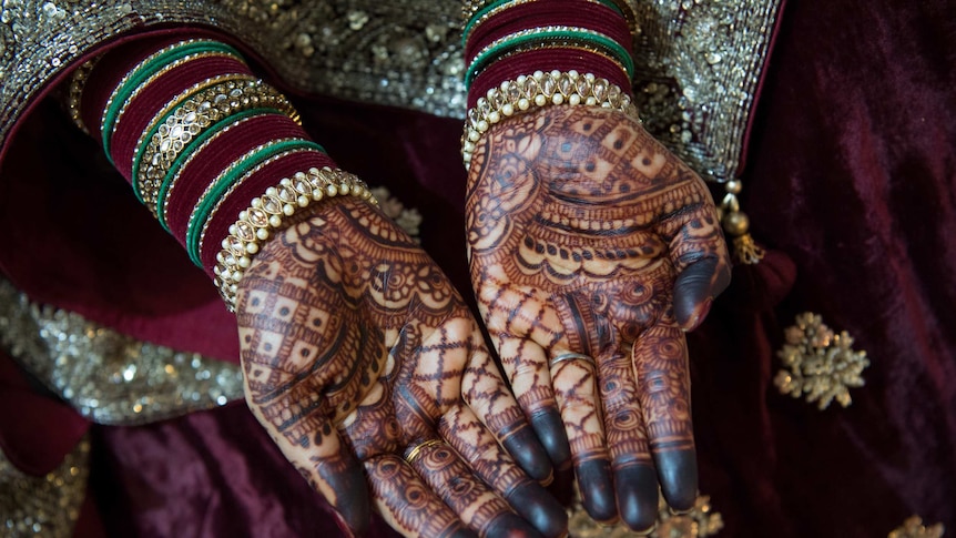 Vivashni's hands are very dark where the henna has bled.