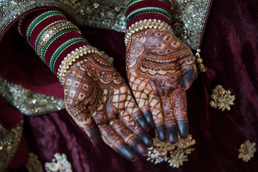 Vivashni's hands are very dark where the henna has bled.