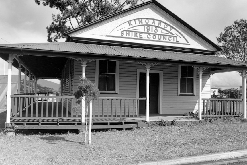 A black and white photo of a timber building with a sign that reads Kingaroy Shire Council