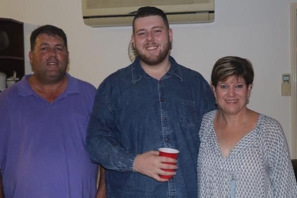 nick ham smiling with his mother and father by his side