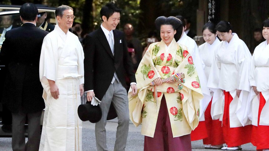 Japanese Princess Ayako, centre right, and Japanese businessman Kei Moriya arrive for their wedding ceremony.