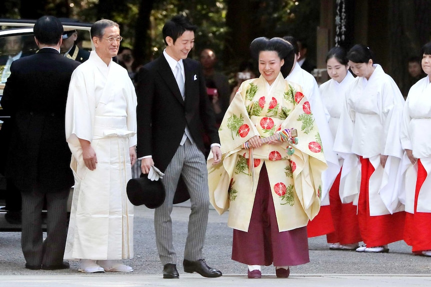 Japanese Princess Ayako, centre right, and Japanese businessman Kei Moriya arrive for their wedding ceremony.