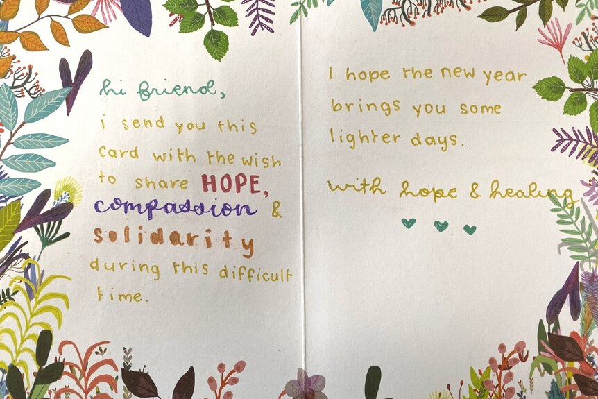A brightly coloured card holds a message of "hope, compassion and solidarity".