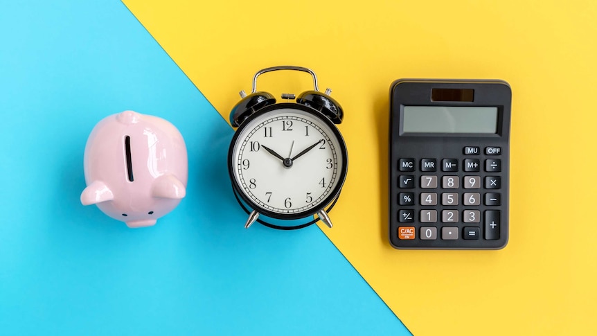 A piggy bank, alarm clock and a calculator on a blue and yellow background.