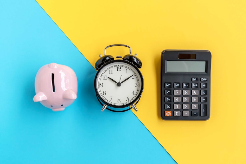 A piggy bank, alarm clock and a calculator on a blue and yellow background.