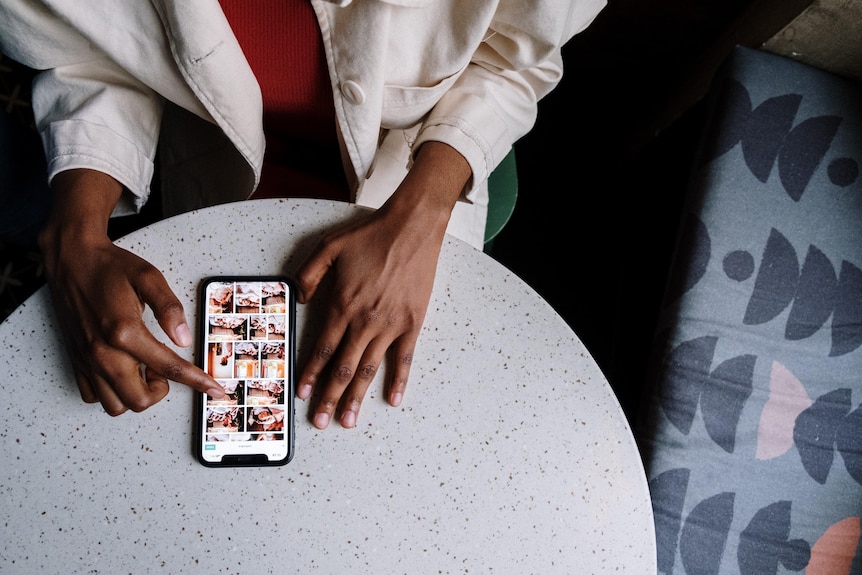 Person in White Long Sleeve Shirt Holding Silver Iphone 6