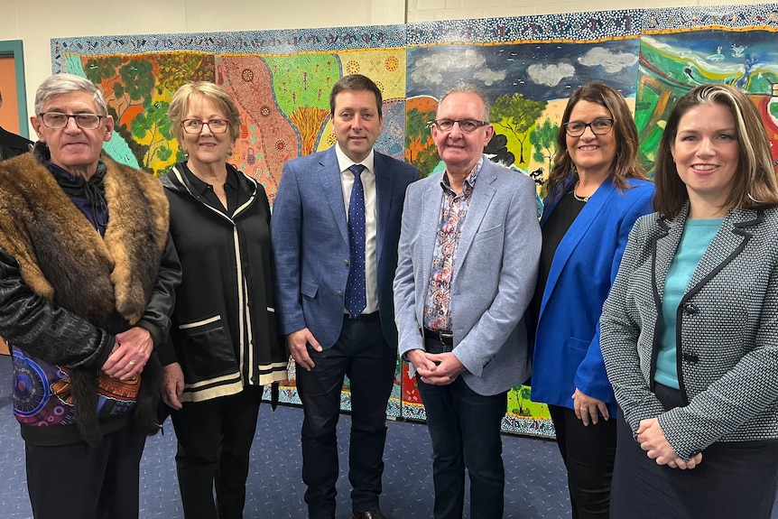 Six community leaders standing together looking at the camera