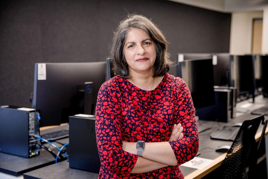 Professor Shazia Sadiq stands in a computer lab at the University of Queensland.