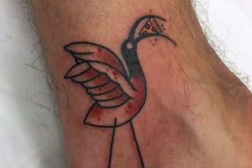 A photo of a tattoo on a man's ankle, the tattoo is of a cartoon ibis