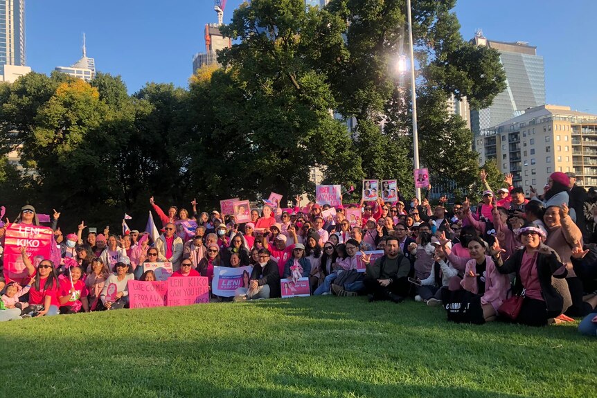 A group of Leni supporters wearing pink pose in a Melbourne park.  
