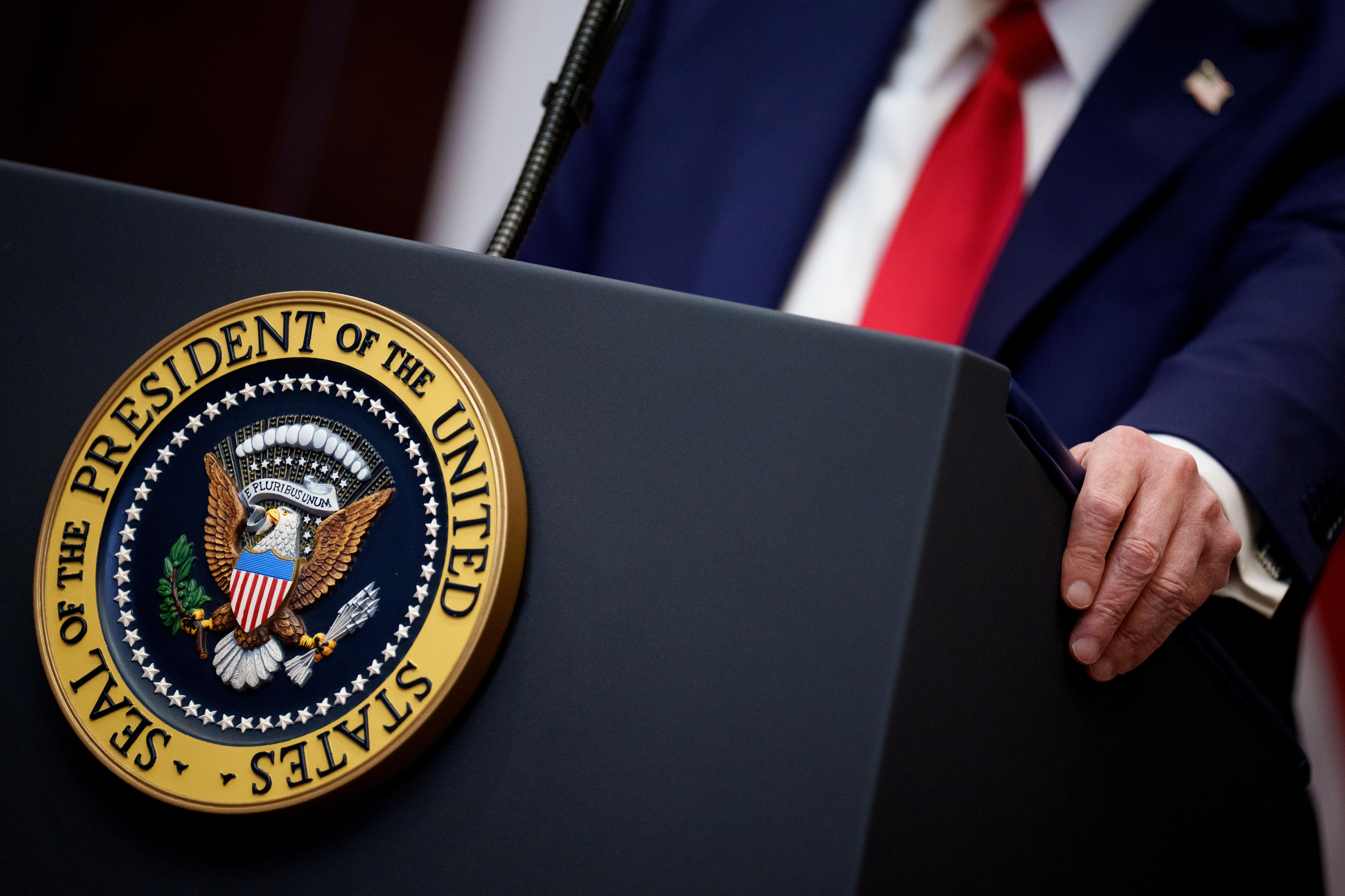 A man's hand with a sign saying the president of the united states