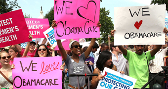 Supporters react to the US Supreme Court decision to uphold Obamacare.