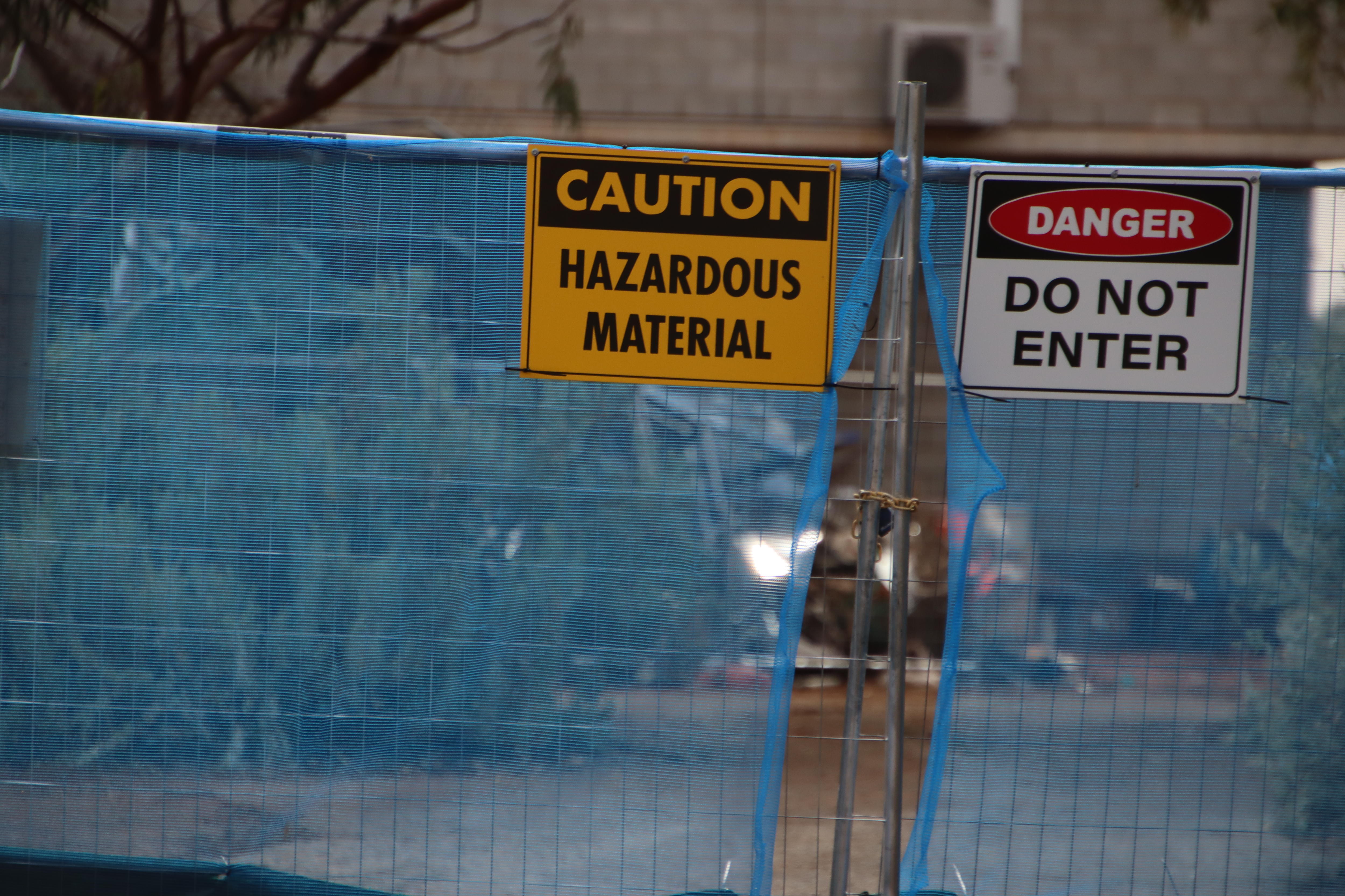 A fenced off area with debris in the background
