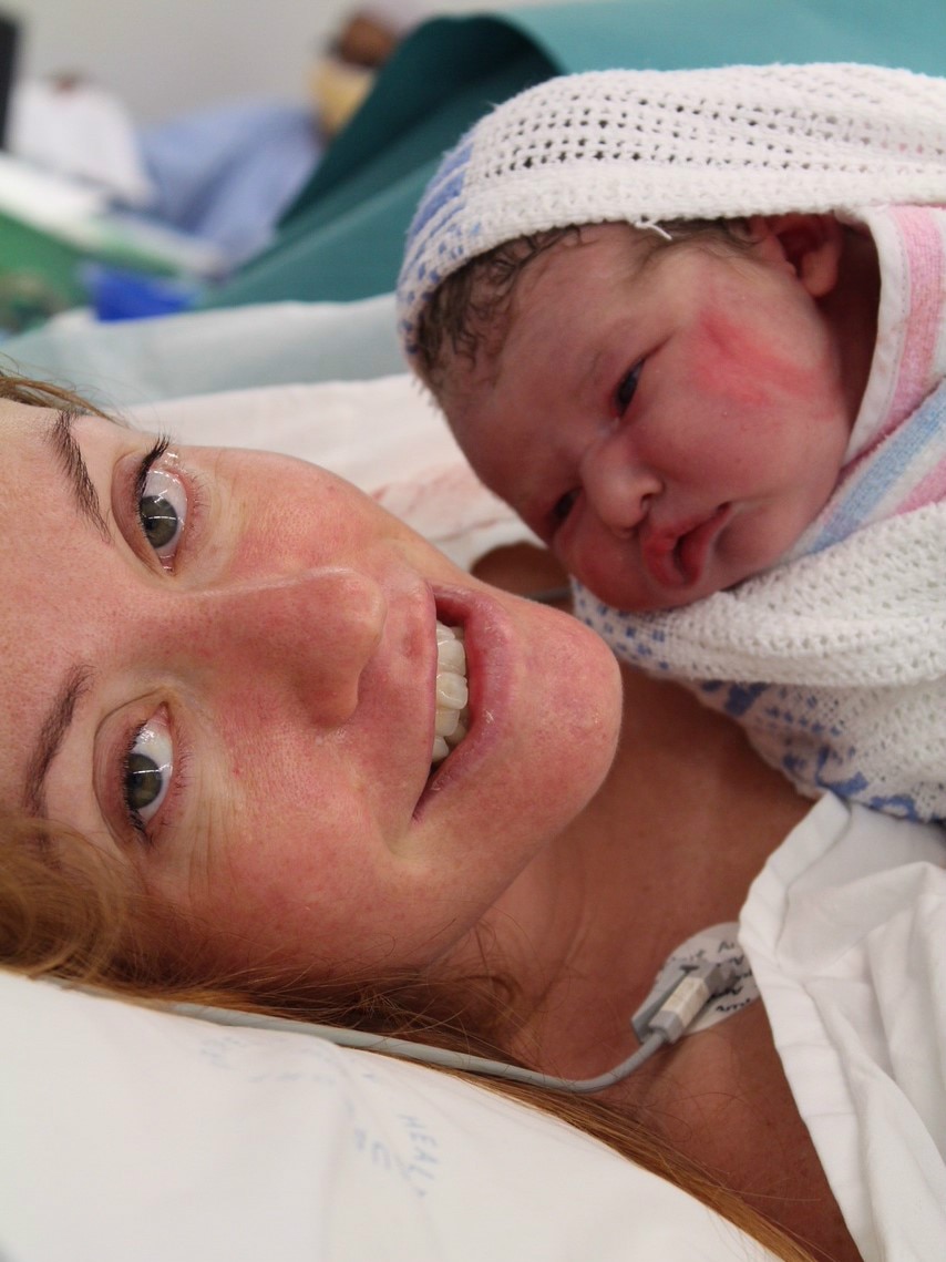 Amy Dawes holds her baby in the maternity ward