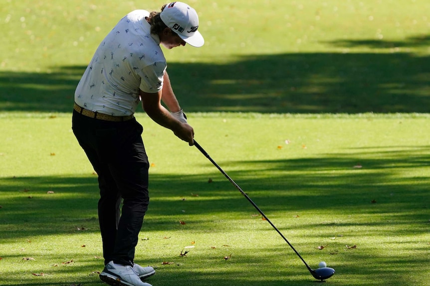 Cameron Smith makes contact with the ball as he drives off the tee