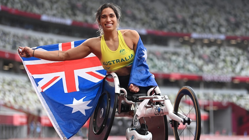 Paralympic gold medallist smiling with the Australia flag after winning gold in the women's marathon