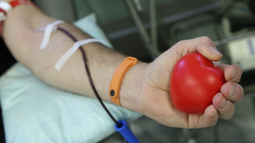An arm with tubes attached donating blood