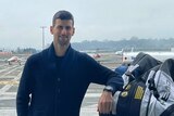 A social media image of Novak Djokovic on an airport tarmac leaning on bags