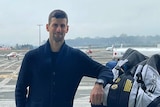 A social media image of Novak Djokovic on an airport tarmac leaning on bags