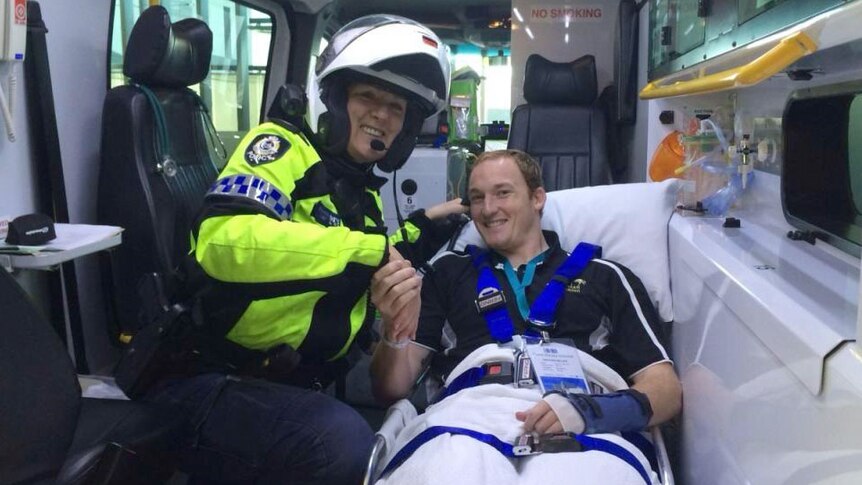 The first patient, Nathan Miller, to be transferred to Fiona Stanley Hospital via ambulance with a police officer