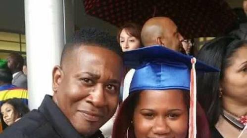 Orlando shooting victim Paul Terrell Henry posing for a photo with a girl in a graduation gown, believed to be his daughter