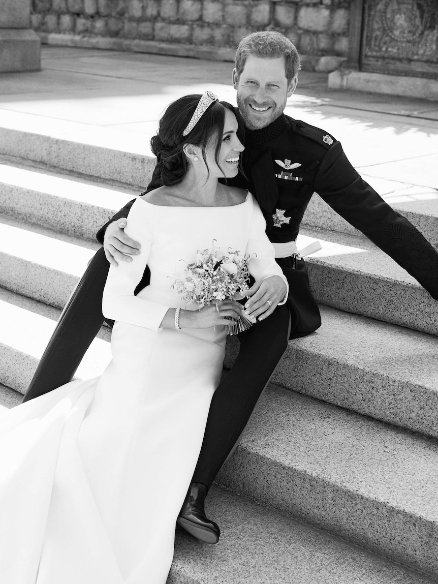 Prince Harry and Meghan Markle sit on the steps on the East Terrace of Windsor Castle.