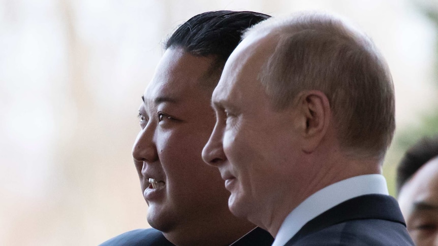 Kim Jong-un smiles as he stands with Vladimir Putin in Vladivostok.
