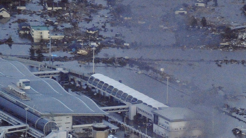 Sendai airport is engulfed by the massive wall of water.