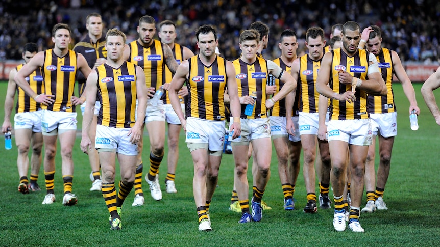 The Hawthorn side walks off the MCG after a loss to Geelong in round 15, 2013.
