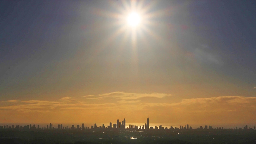 The sun rises high over the Gold Coast skyline