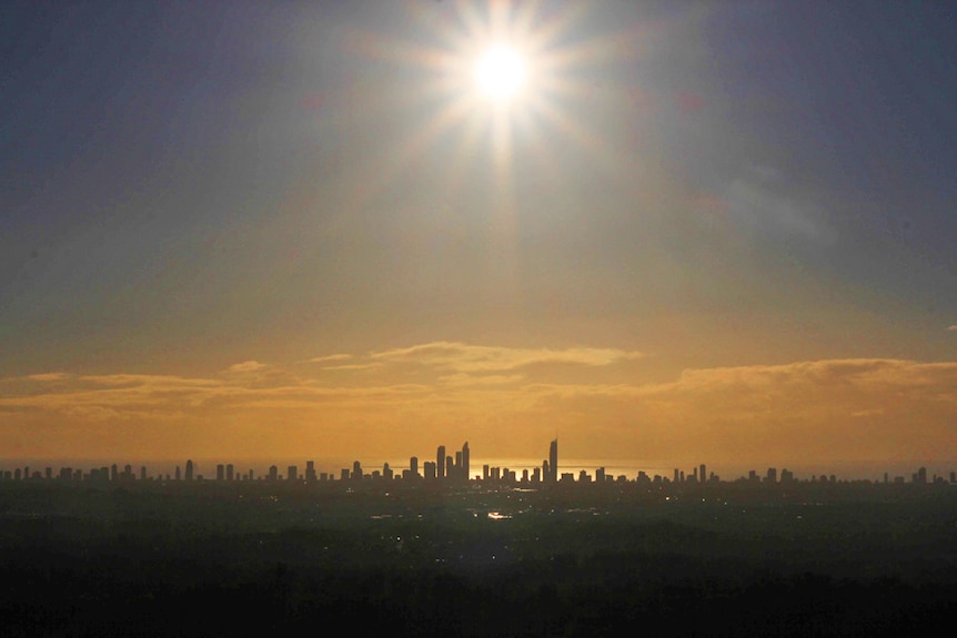 The sun rises high over the Gold Coast skyline