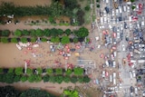 Aerial photo shows rescue workers deploy life rafts for evacuating residents during floods.
