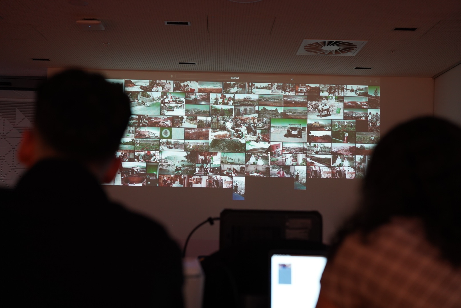 an image projected onto a wall shows houses