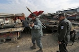 Afghan policemen patrol the area where one of the rockets landed in Kabul.