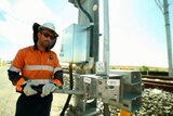 A man works on the electrification of the Moreton Bay Rail Link.