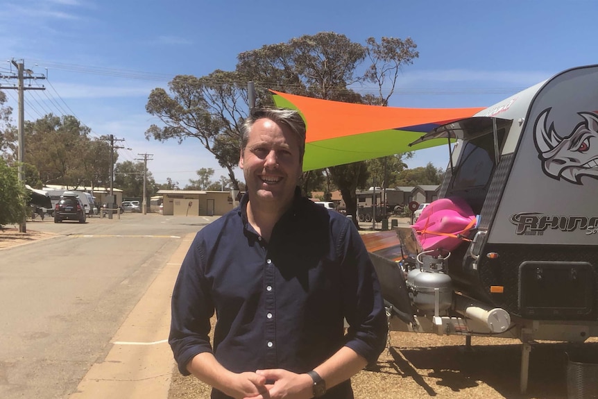 man stands in caravan park