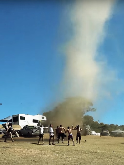 Festival goers dance around a dust devil that formed in Pyalong.