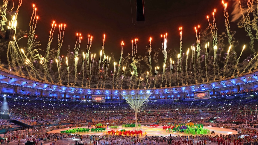 Fireworks go off after the Olympic flame is extinguished during the closing ceremony.