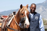 Nevada prisoner standing with horse