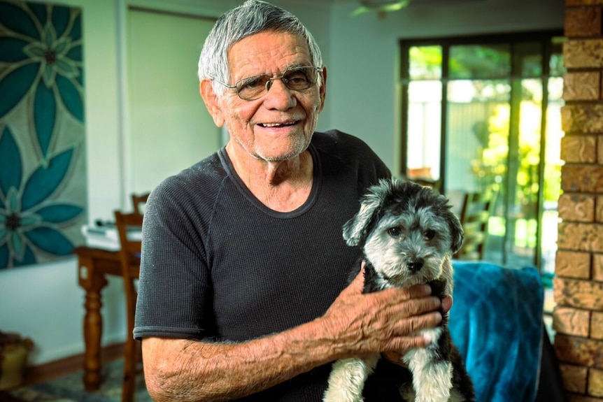 Uncle John holds his pet dog shitzu cross Yarrin