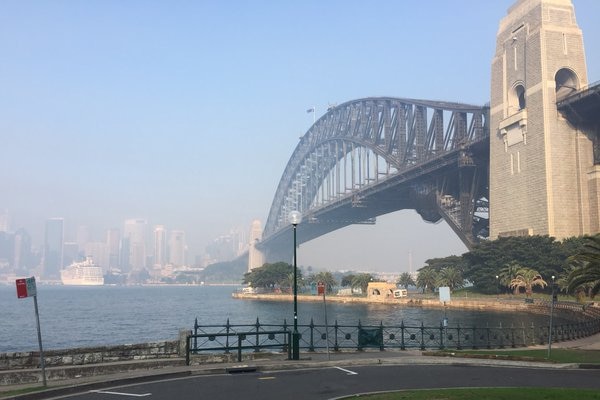 A view of the Sydney Harbour Bridge shrouded in smoke.