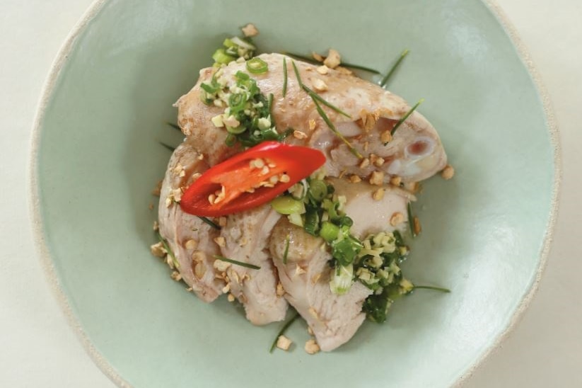 A vertical view of a chicken dish, with chilli and wax foliage flavouring.
