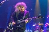 The Cure perform on stage.
