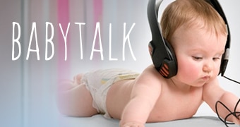 A baby wearing headphone with the 'babytalk' logo.