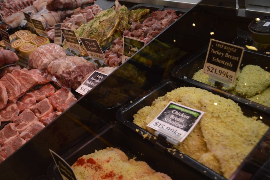 A butcher's window filled with chicken & turkey schnitzels and different cuts of lamb